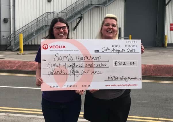 Representatives from Sam's Workplace in Rainworth proudly showing off the cheque they have received.