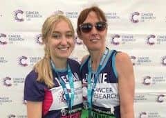 Joanne Nelson and daughter Megan with their medals after completing the Great North Run and raising £1,000 for Cancer Research UK.