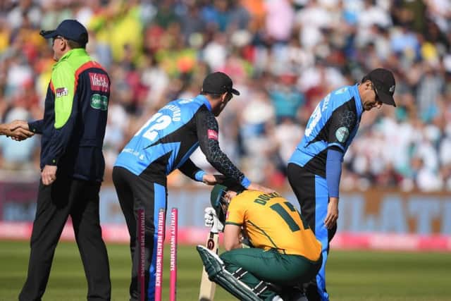 Hamish Rutherford and Daryl Mitchell of Worcestershire Rapids console Ben Duckett of Notts after defeat during the Vitality T20 Blast semi-final.