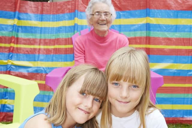 Resident Ivy Brooks enjoyed playing in the sand with youngsters Maddison and Rebekka. (PHOTO BY: Richard Tatham)