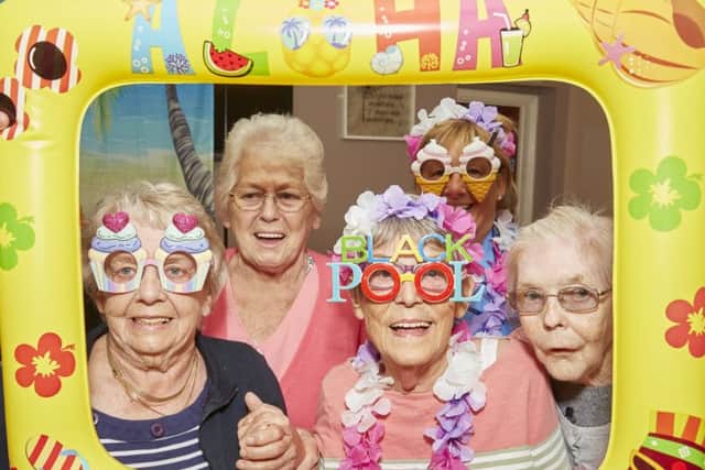 Picture postcard fun for these Richmond residents as they get in the holiday mood. They are (from left): Brenda Smith, Shirley Dolling and Cath Edwards, with staff member Sue Bills at the back. (PHOTO BY: Richard Tatham)