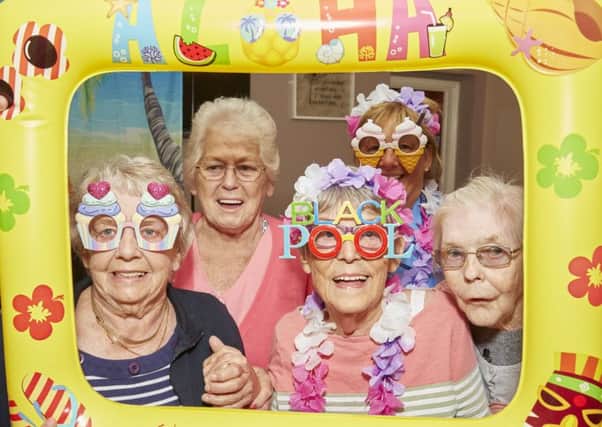 Picture postcard fun for these Richmond residents as they get in the holiday mood. They are (from left): Brenda Smith, Shirley Dolling and Cath Edwards, with staff member Sue Bills at the back. (PHOTO BY: Richard Tatham)