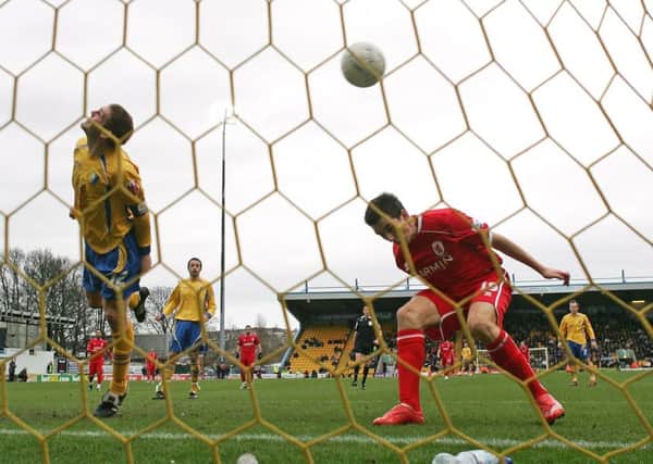 MANSFIELD, UNITED KINGDOM - JANUARY 26:  Jake Buxton of Mansfield Town heads the ball in to his own net under pressure from Stewart Downing of Middlesbrough to score an own goal during the FA Cup 4th round match sponsored by E-on at Field Mill on January 26, 2008 in Mansfield, England.  (Photo by Alex Livesey/Getty Images)