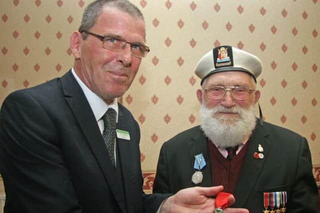 Reg Taylor with his Legion d'honneur medal and Clipstone parish councillor Karl Beresford