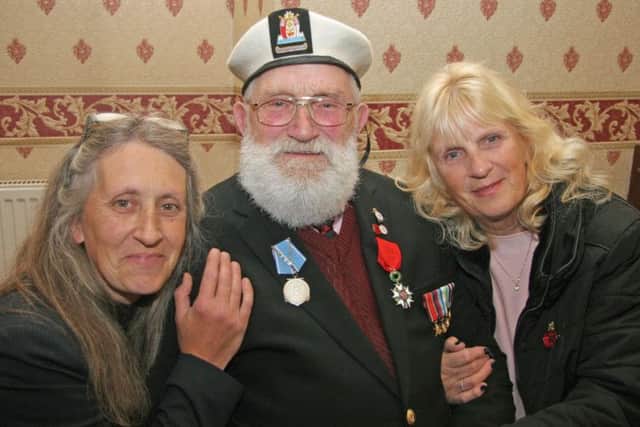 Reg Taylor with his Legion d'honneur medal and daughters Wendy Tryner and Susan Downing.