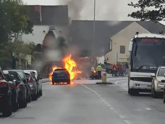 The car on fire taken by Dwayne Wright.
