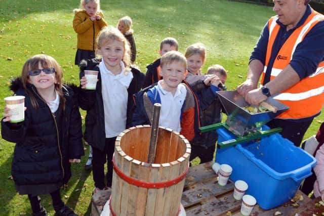 Children from Hillocks Primary School make apple juice.
