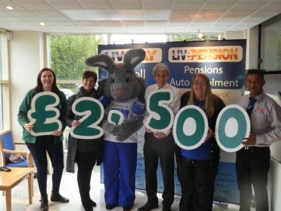 Receiving the cheque for Macmillan is Katherine Booth, and in attendance were Sarah Maude and the Radio Mansfield 103.2 rabbit Warren, Keith and Sylvia Johnson, and Rais Uddin from the Naaz Restaurant.