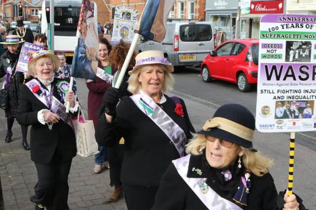 The WASPI women protest dressed as Suffragettes.