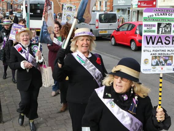 The WASPI women protest dressed as Suffragettes.