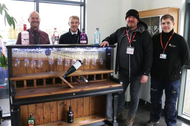 Nicholas Hibbitt (second right) is presented with his piano bar by tutors Andy Whyley (left) and Reece Pridmore, and a student Daniel Stainwright.