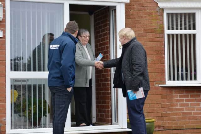 Boris Johnson and Ben Bradley speak to a Mansfield resident.