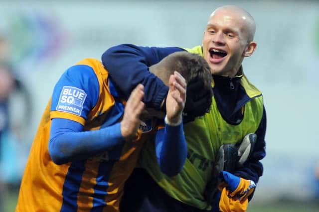Mansfield Town v Barrow.Fans man of the match Stevenson gets attention from Meikle.