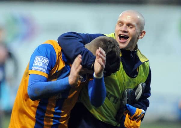 Mansfield Town v Barrow.
Fans man of the match Stevenson gets attention from Meikle.