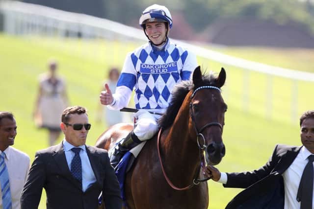 Jockey James Doyle (centre) celebrates winning the Coral-Eclipse on Al Kazeem during the Coral-Eclipse Day at Sandown Park Racecourse, Esher. PRESS ASSOCIATION Photo. Picture date: Saturday July 6, 2013. See PA story RACING Sandown. Photo credit should read: Nick Potts/PA Wire
