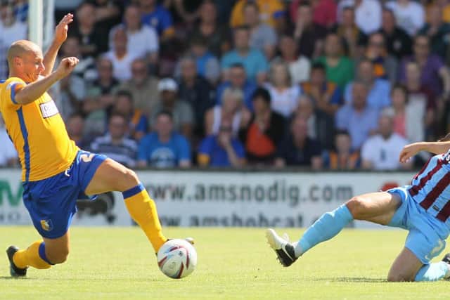 Skipper Adam Murray battles for the ball with Scunthorpe's Matt Sparrow -Pic by:Richard Parkes
