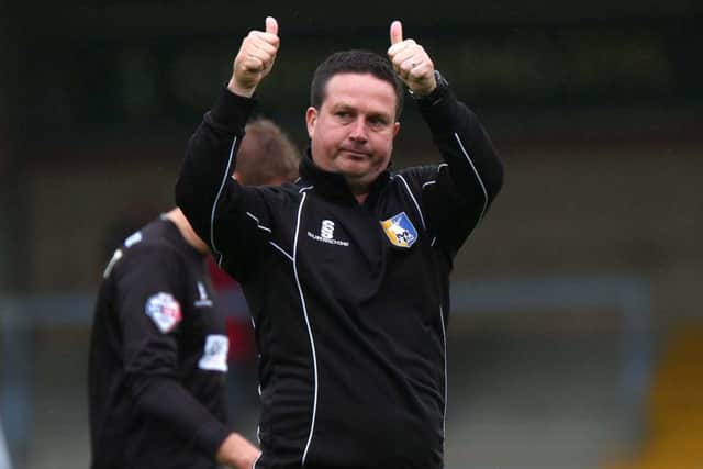 With the season's first win chalked up, manager Neil Cox gives a big thumbs up to the Stags' fans at the final whistle.