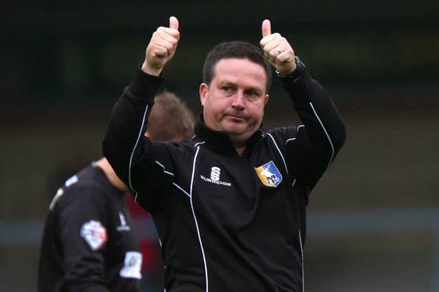 With the season's first win chalked up, manager Neil Cox gives a big thumbs up to the Stags' fans at the final whistle.