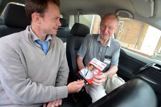 Frank Duckmanton the secretary and senior observer with the Mansfield Group of Advancey Motorists goes through some of the points with Chad's Ben McVay.