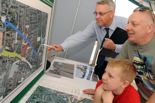 Chris Wood from Highways NCC  left talks to members of the public about the new proposed regeneration scheme for Hucknall Town Centre Pictured talking to residents Stev and Liam Allen