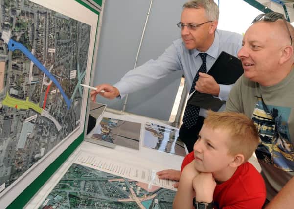 Chris Wood from Highways NCC  left talks to members of the public about the new proposed regeneration scheme for Hucknall Town Centre Pictured talking to residents Stev and Liam Allen