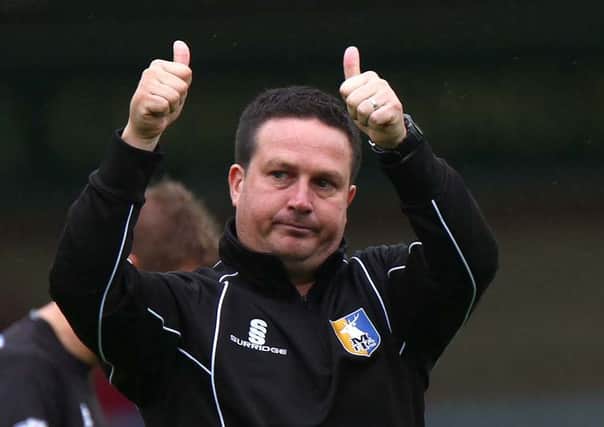 With the season's first win chalked up, manager Neil Cox gives a big thumbs up to the Stags' fans at the final whistle.