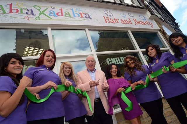 Mansfield Mayor Tony Egginton cuts the ribbon with owner Alejandra Cooling-Valencia and her staff at the opening of Abrakadabra Hair and Beauty on Church Side in Mansfield on Saturday.