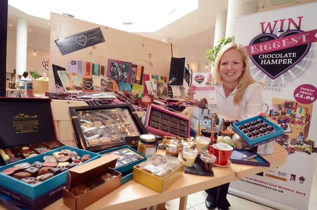 Lisa Morrow from Chocolat Lovers with the huge selection of chocolat to make up the 'biggest hamper ever' offered as a prize to raise money for the Alzheimer's Society and The Sick Children's Trust, pictured during a one day only stop off at the East Midlands Designer Outlet.