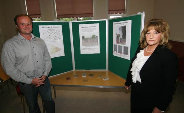 Local campaigners show the plans for the proposed war memorial in Selston