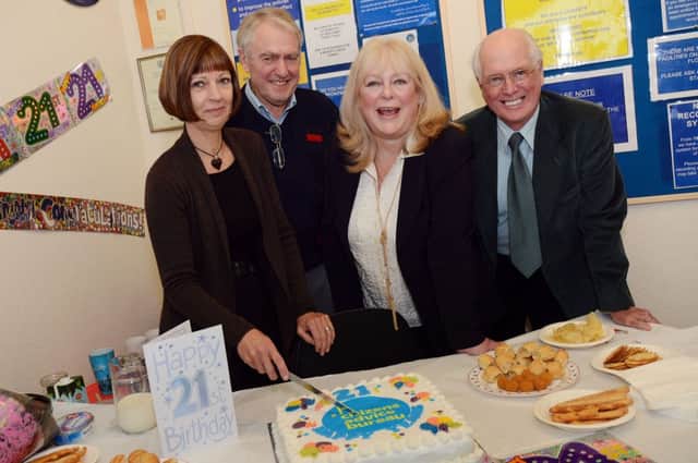 Sutton CAB's longest serving staff cut their 21st anniversary celebration cake at a get-together presentation at their Market Street office last Thursday, they are from left, service manager, Janis Abraham, trustee, Ken Marshall, chief executive Sue Davis and trustee Gordon Wilson.