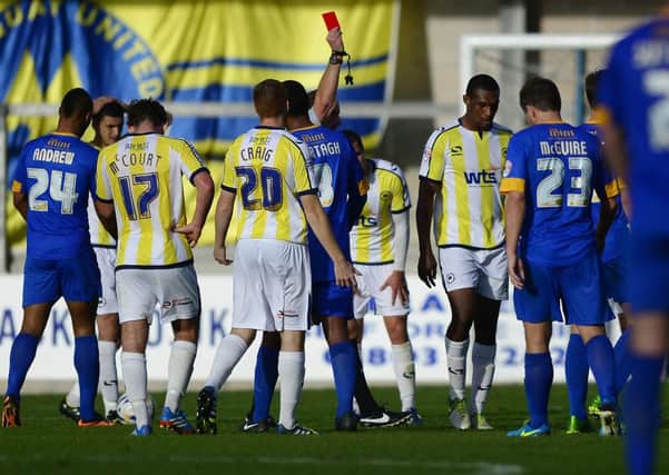 Torquay United's Krystian Pearce (2R) is shown a red card from, Referee Mick Russell after bringing down Sam Clucas of Mansfield Town - Photo mandatory by-line: Dan Mullan/Pinnacle - Tel: +44(0)1363 881025 - Mobile:0797 1270 681 - VAT Reg No: 768 6958 48 - 19/10/2013 - SPORT - FOOTBALL - Sky Bet League Two - Torquay United v Mansfield Town, Plainmoor, Torquay, Devon.