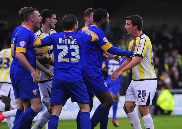 Lee Beevers of Mansfield Town (2L) clashes with Torquay United's Elliot Benyon (R) - Photo mandatory by-line: Dan Mullan/Pinnacle - Tel: +44(0)1363 881025 - Mobile:0797 1270 681 - VAT Reg No: 768 6958 48 - 19/10/2013 - SPORT - FOOTBALL - Sky Bet League Two - Torquay United v Mansfield Town, Plainmoor, Torquay, Devon.