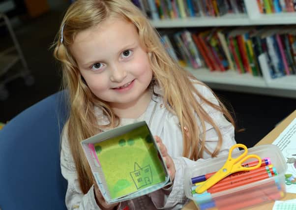 Isabelle O'Connor shows off her vision of tomorrow, created on a keepsake box at the Big Draw event in Hucknall Libary last Friday.