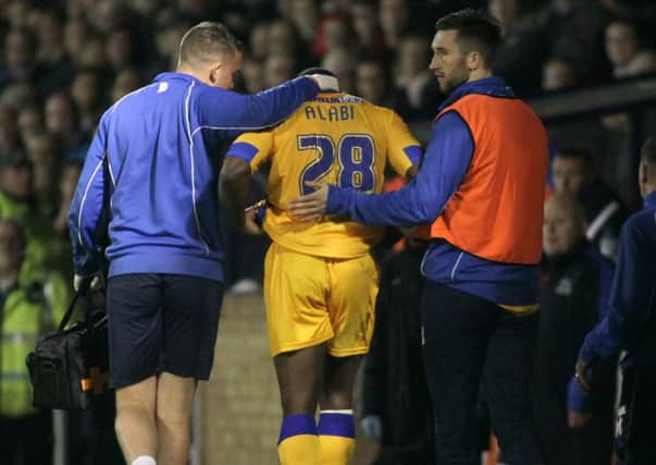 James Alabi is consoled by physio Simon Murphy and Ollie Palmer after receiving the red card  -Pic by:Richard Parkes