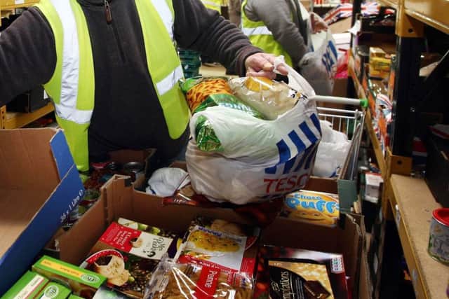 Workers preparing food parcels at a foodbank.