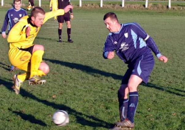 Bentley Colliery v Glapwell.  Bentley captain Phil Doran clears the ball despite an opponent jumping in.  Picture: Malcolm Billingham