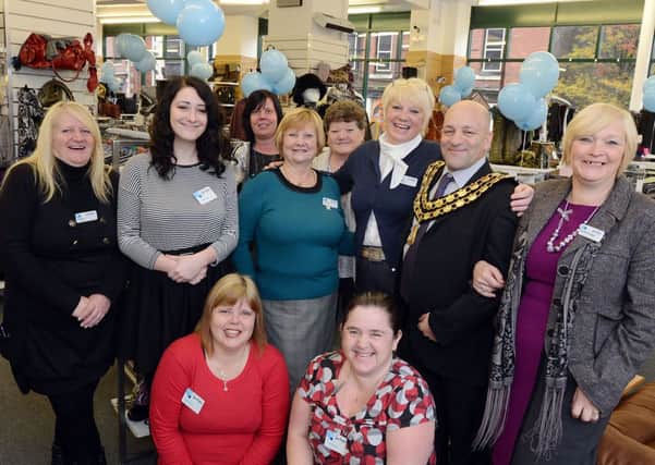 The Sue Ryder charity shop manager, Magdaleana Dawson, standing third right, pictured with her guest Ashfield District Council Chairman, Coun. Linford Gibbons at the opening of the Ogle Street shop after refurbishment following flood damage.