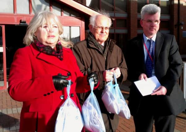 Ashfield CAB's Sue Davis and Peter Robinson hand a petition to Dave Greenwood, Ashfield District Council's deputy chief executive.