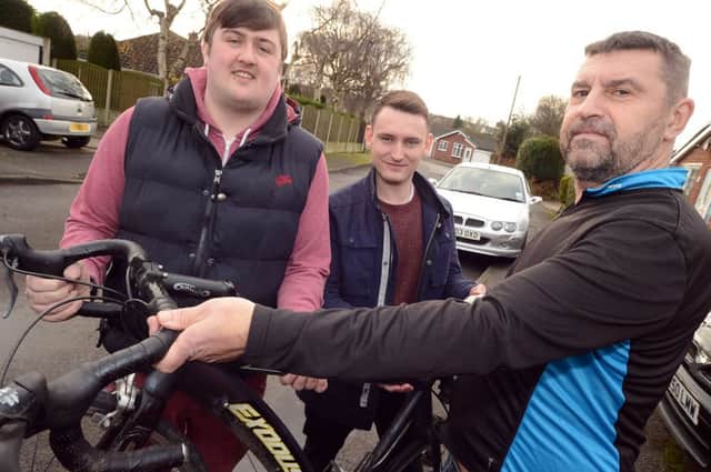 Steve Fleming, right, is handed back his bike by Nick Yuill, centre and Robert Harrison who came to his aid when he had an accident on the A611 recently.