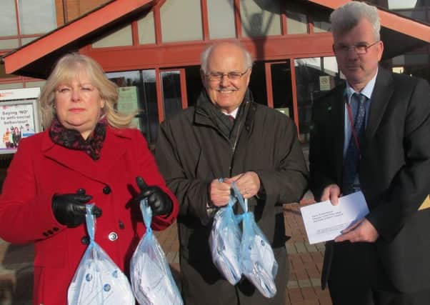 Sue Davis and Peter Robinson from Ashfield CAB hand over the petition to Dave Greenwood from Ashfield District Council