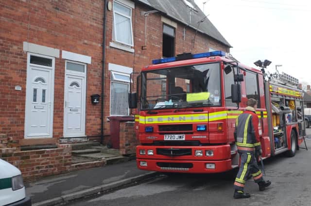 Derbyshire Fire crews dampen down after a house fire on Ann Street, Creswell  (w120208-10d)