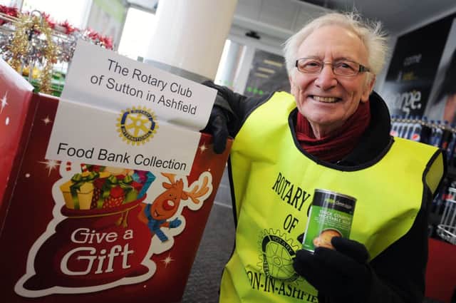 Sutton-in-Ashfield Rotary Club at Asda with Santa and his sleigh handing out gifts to children. Pictured is Phil Bustin with the Food Bank Collection.