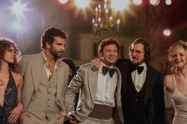 Undated Film Still Handout from American Hustle. Pictured: (l to r) Amy Adams, Bradley Cooper, Jeremy Renner, Christian Bale and Jennifer Lawrence. See PA Feature FILM Film Reviews. Picture credit should read: PA Photo/Entertainment Film Distributors. WARNING: This picture must only be used to accompany PA Feature FILM Film Reviews.