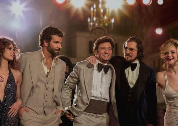 Undated Film Still Handout from American Hustle. Pictured: (l to r) Amy Adams, Bradley Cooper, Jeremy Renner, Christian Bale and Jennifer Lawrence. See PA Feature FILM Film Reviews. Picture credit should read: PA Photo/Entertainment Film Distributors. WARNING: This picture must only be used to accompany PA Feature FILM Film Reviews.