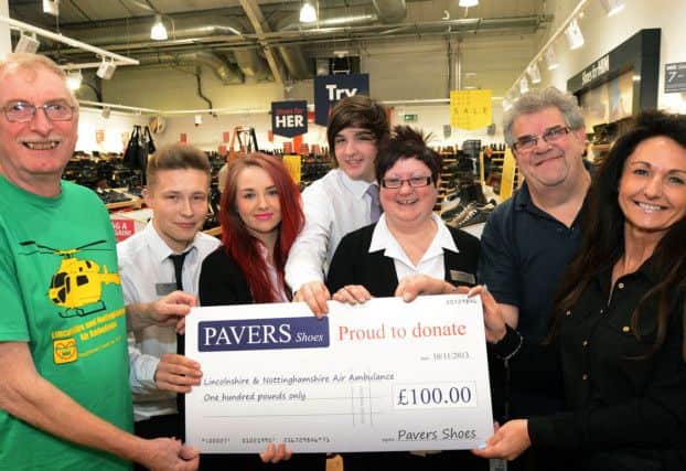 Store manager, Gail Day right, from the Pavers shop at the East Midlands Designer Outlet, hands over a £100 cheque to Dave Gibbon, left, from the Lincs and Notts Air Ambulance, after the charity was chosen as the local recipients to celebrate the chain's 100 store opening. Also pictured are staff, Jordan Whittaker, Asha Priestley, Jake Draycott, Jane Adlington and Robert Thompson.