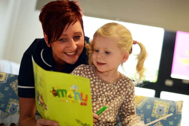 Ward 25 leader, Deb Farn goes through the menu with Lilly Beastall after Kings Mill Hospital launched new child friendly meals.