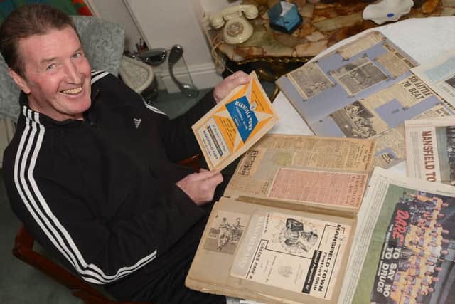 Ivan Hollett looking back at his scrap books from his Mansfield days.