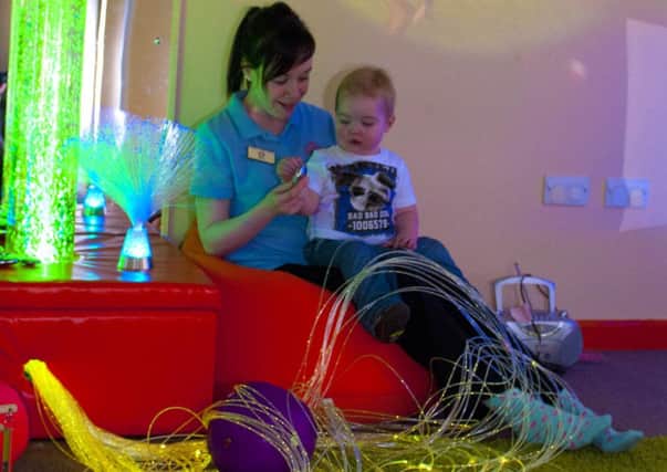 Ryan Black enjoys the newly opened sensory room at the Alphabet House Nursery, Farnsfield with staff member Kerry Shannon, The sensory room which will help children with special needs has been made possible, thanks to the fundraising efforts of Ryan's mum Sally-Anne Charlton.