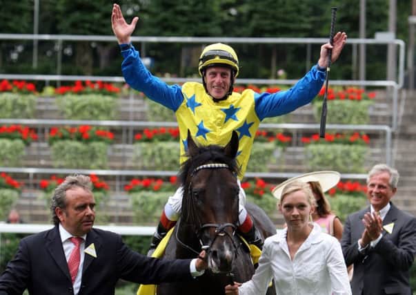 KING GEORGE GLORY -- jockey Johnny Murtagh celebrates victory on board Novellist in last year's King George at Ascot (PHOTO BY: Steve Parsons/PA Wire)