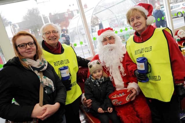 Sutton-in-Ashfield Rotary Club at Asda with Santa and his sleigh handing out gifts to children. l-r is Jodie Smith, Phil Bustin, Isla Cameron 4, Santa, and Pam Whetton President of The Inner Wheel, Sutton.